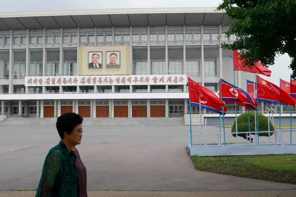  North Korean and Chinese flags fly on a Pyongyang street