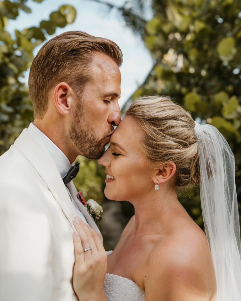  England and Spurs star Harry Hane gave Kate Goodland a gentle kiss as they married after several years together