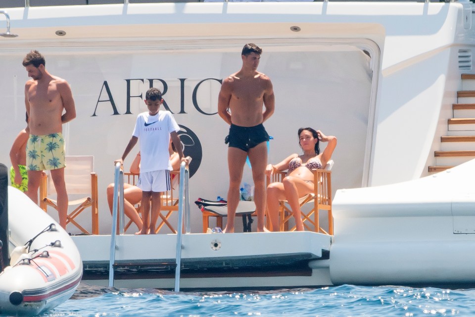 Ronaldo prepares to jump in the water with Cristiano Jr as Rodriguez watches on