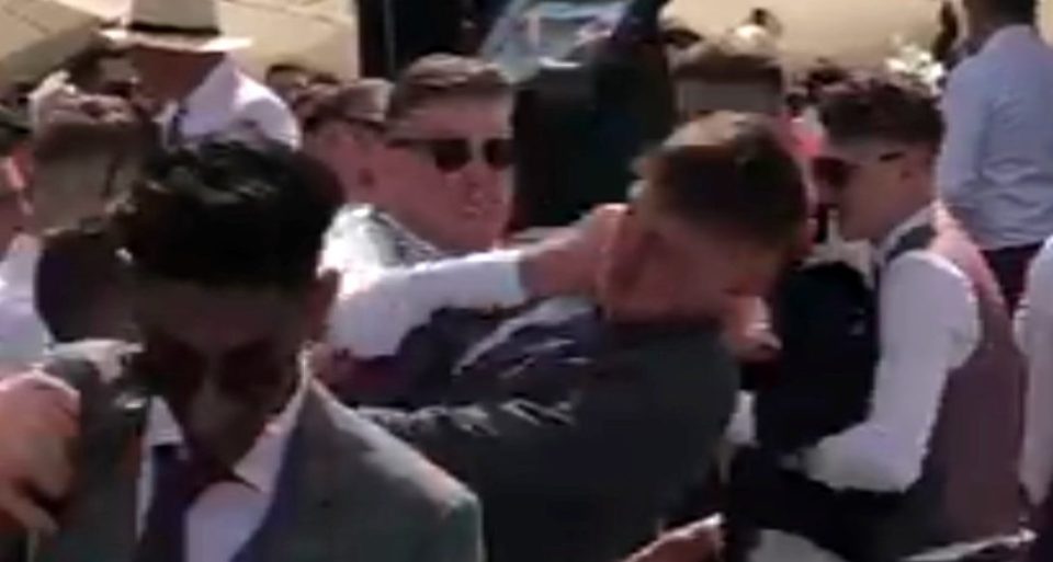  A man throws a punch at another in the chaotic scenes at Royal Ascot