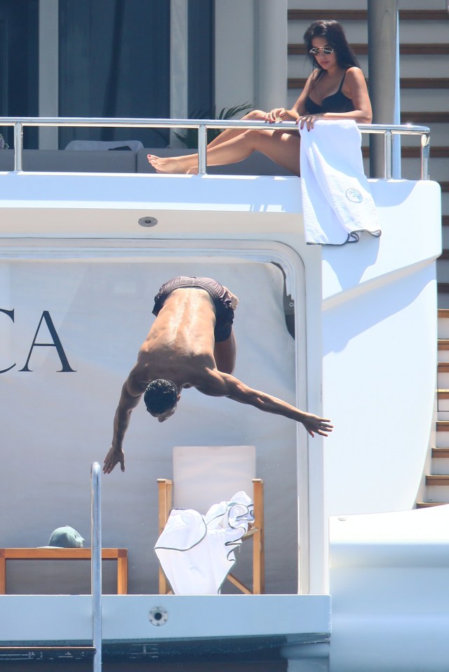 Portuguese superstar Ronaldo dives off the back of the yacht as Rodriguez sunbathes