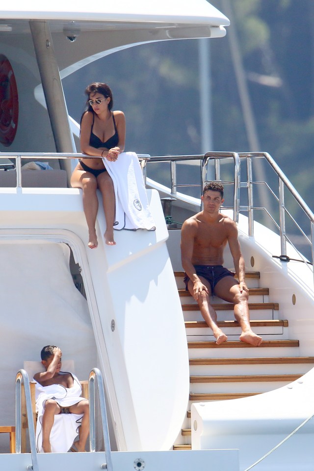 The trio relax on the back of the boat which is anchored in St Tropez 