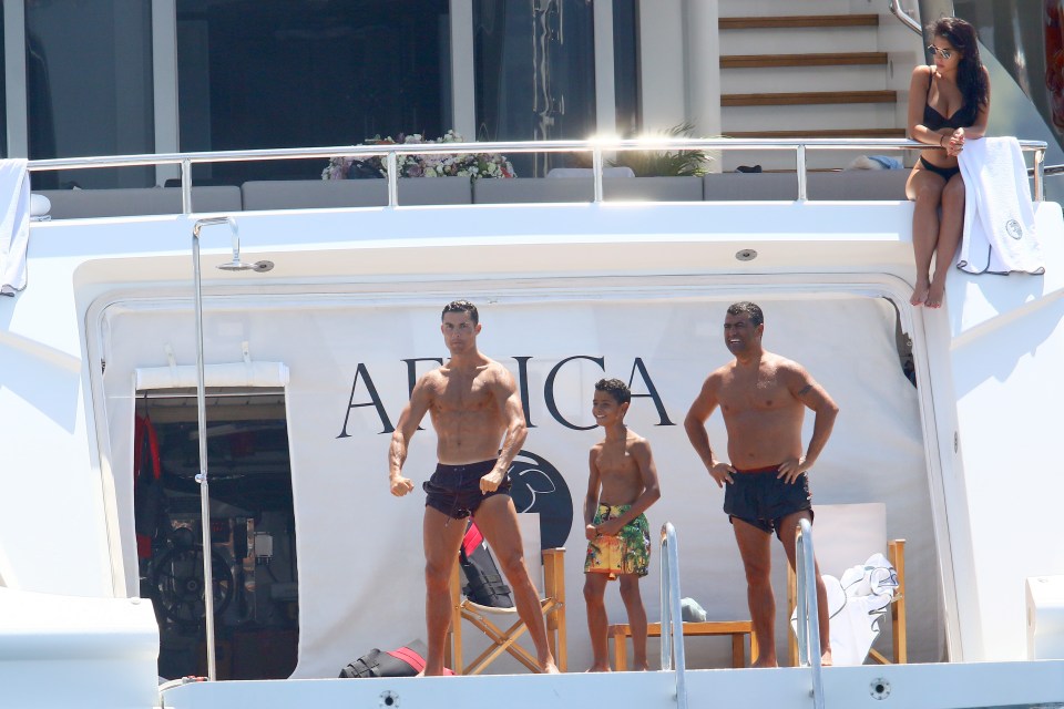 Rodriguez watches on as Ronaldo flexes his muscle before diving in the water