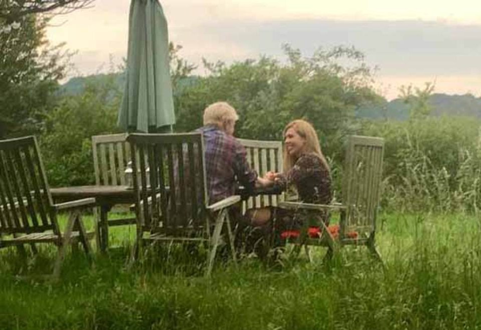  She was pictured smiling around the table in a garden in the country with Boris, who is running to be PM.