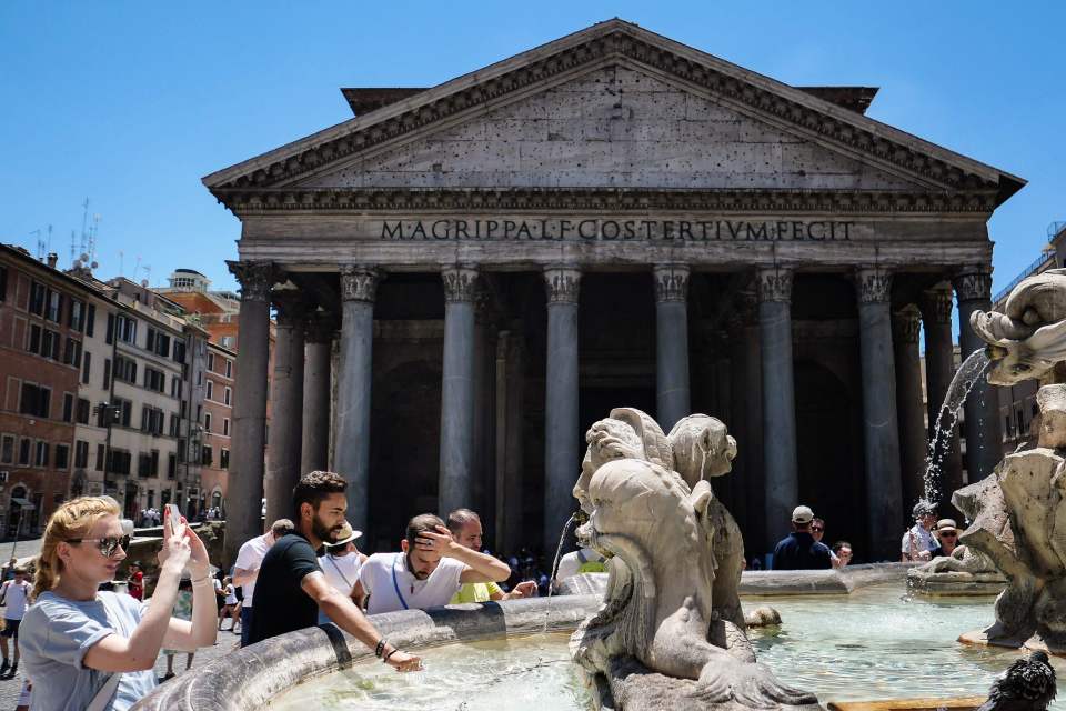  Tourists refresh at a fountain in front of the Pantheon monument during an unusually early summer heatwave on June 24 in Rome, Italy