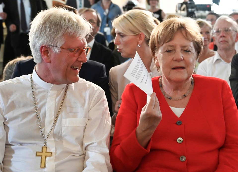 In June Mrs Merkel fanned herself with a piece of paper to cool down in the 40C heatwave