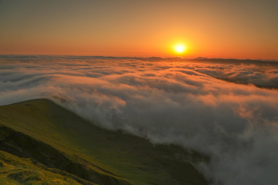  Dramatic sunrise over the Brecon Beacons, Wales with temperature inversion creating clouds at low level