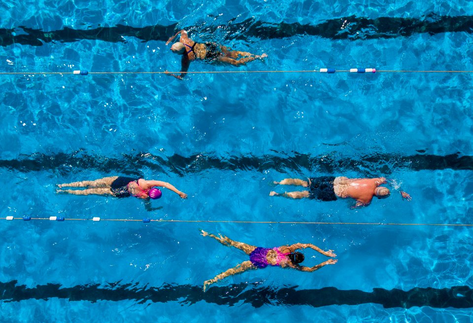  Swimmers basking on the sunshine while getting their morning swim in