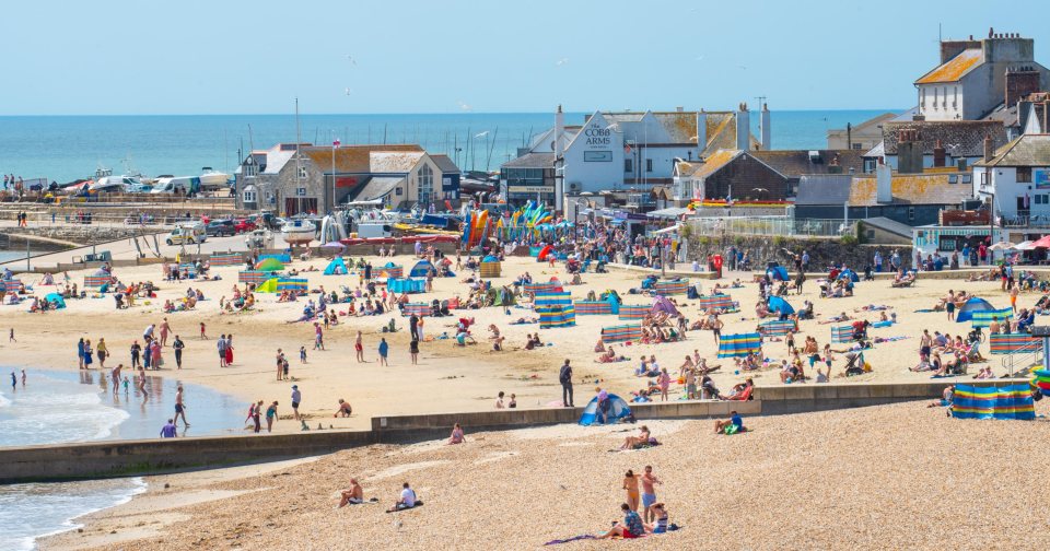  Sunbathers flock to Lyme Regis in Dorset to enjoy a day of clear blue skies and scorching sunshine