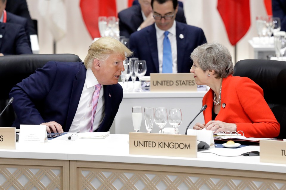 Theresa May can be seen speaking to Donald Trump during the G20's first day