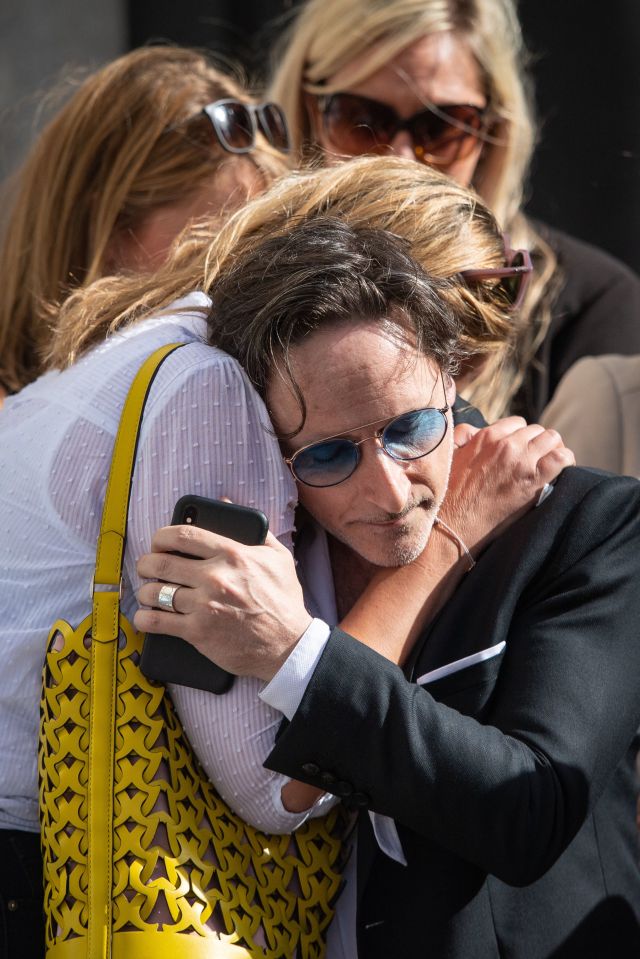  Distraught families hug outside the Old Bailey today