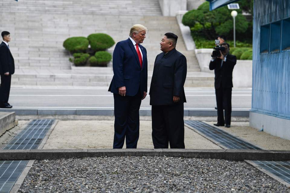  Trump standing next to Kim after stepping foot in to North Korea