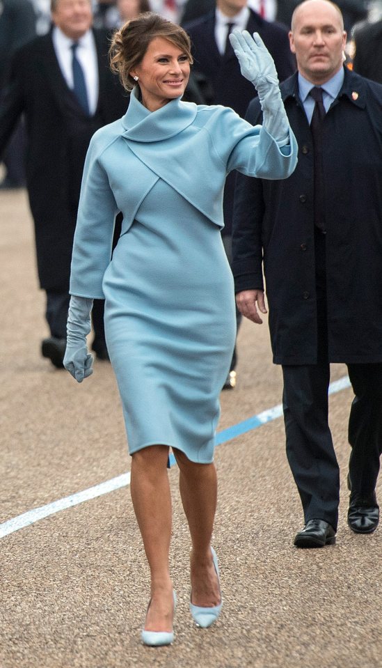  The wooden figure is meant to depict the First Lady in her blue outfit that she wore at President Trump's inauguration