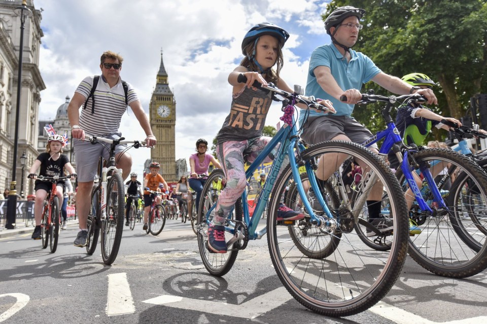 Members of the public ride through Parliament Square during the Prudential RideLondon FreeCycle