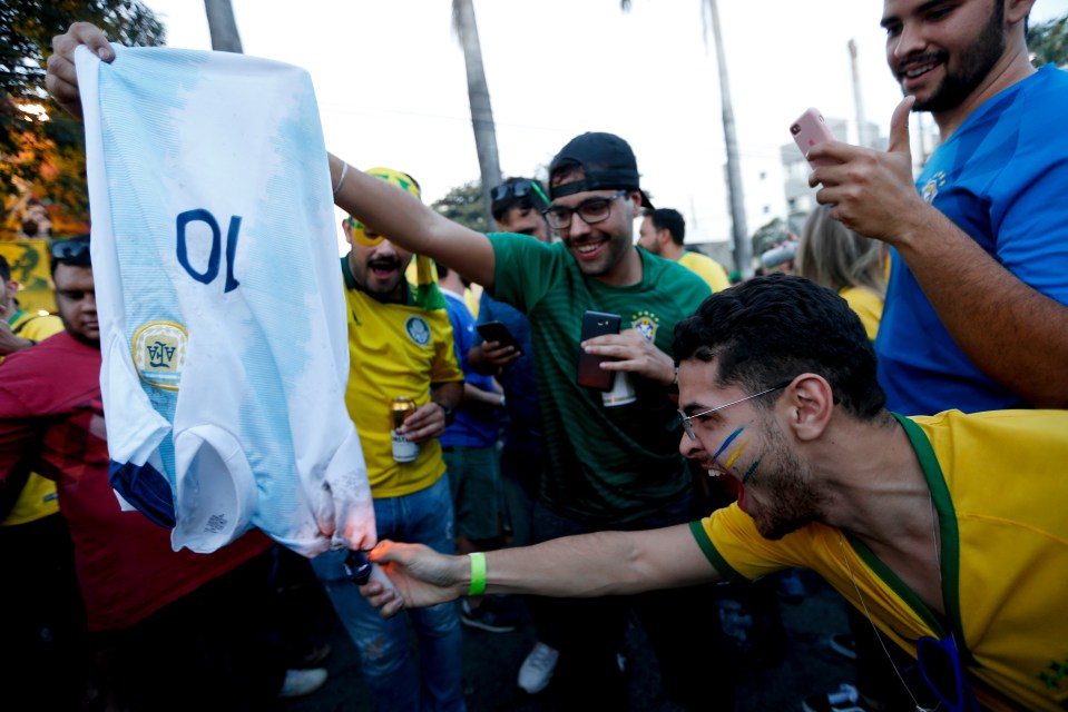 Brazil fans set fire to a Lionel Messi Argentina shirt before the semi-final