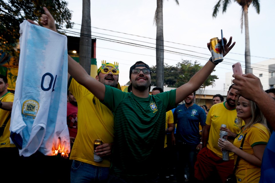 Brazil fans celebrate after setting a Lionel Messi shirt aflame