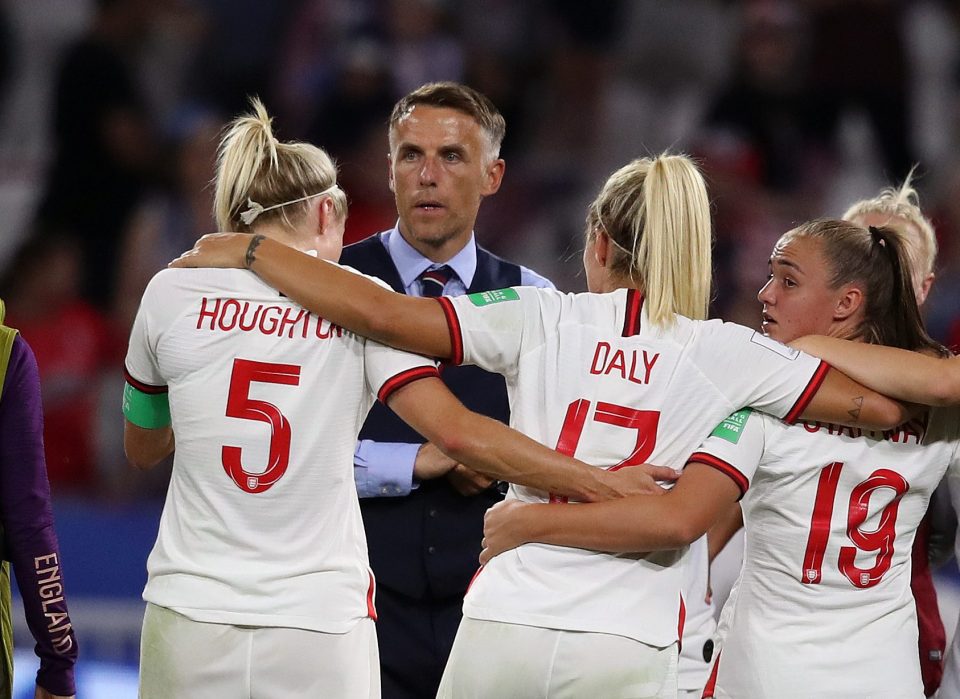  Phil Neville consoles his players after the final whistle in Lyon