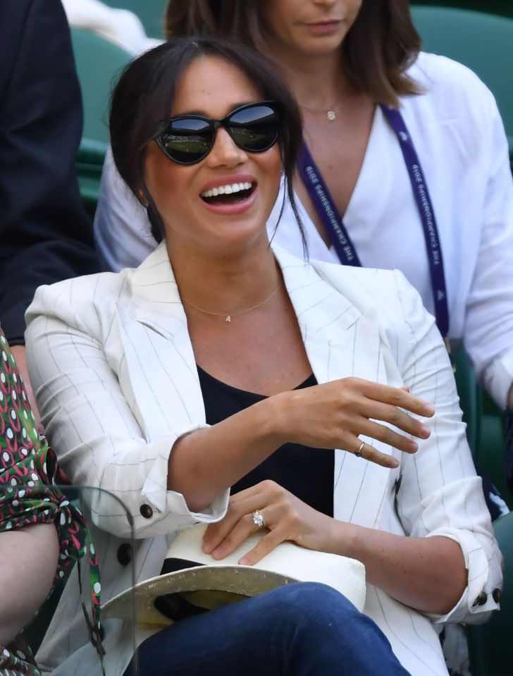  Meghan smiles as she watches Serena Williams take on Kaja Juvan during their women's singles