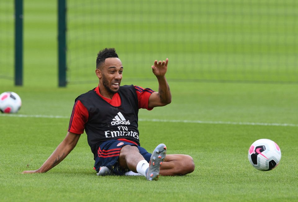  Aubameyang slides along the turf at the London Colney training ground