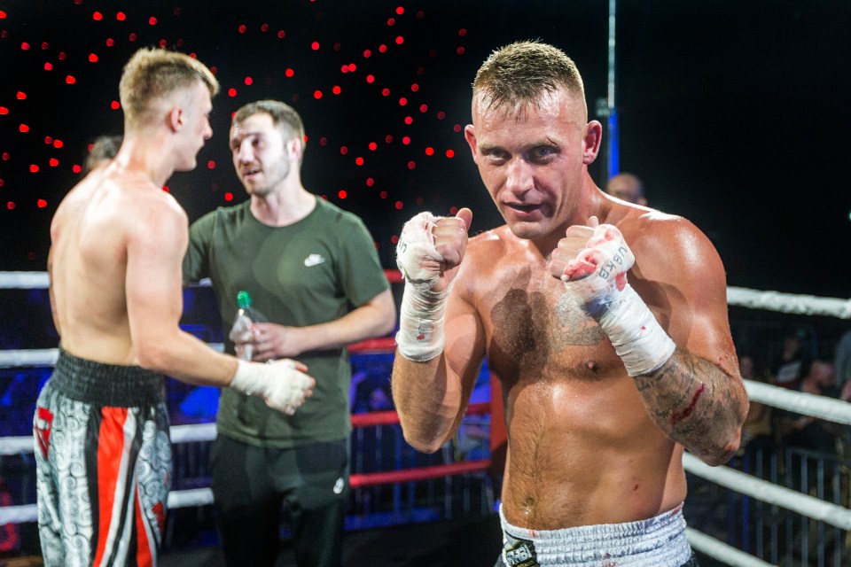  Fighters with bloodied fists in the ring