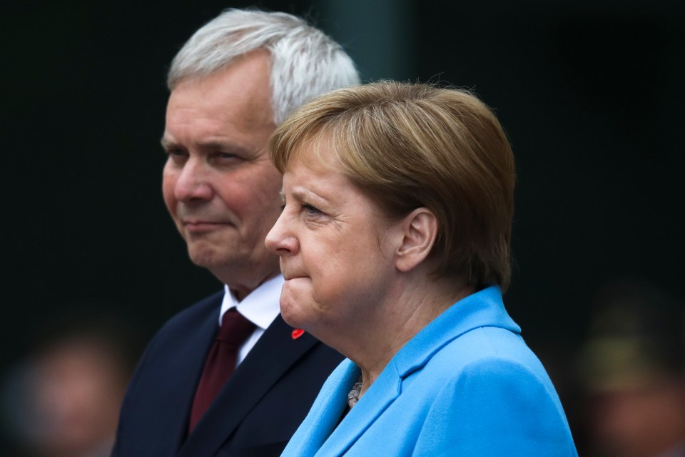 The German chancellor looked uncomfortable, biting her lip at the event