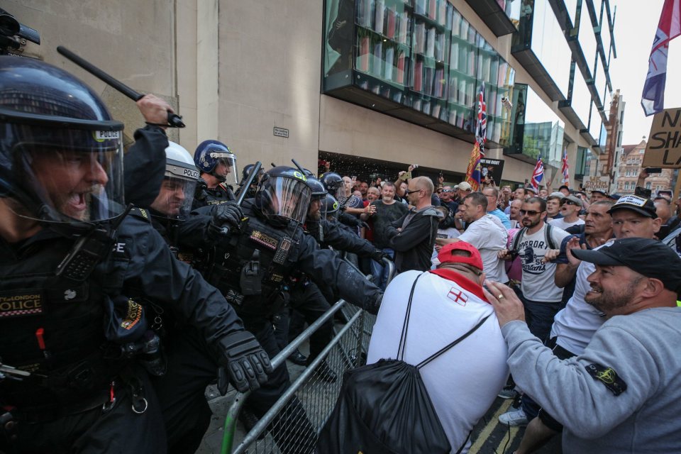  Police can be seen armed with batons as protesters and officers clashed