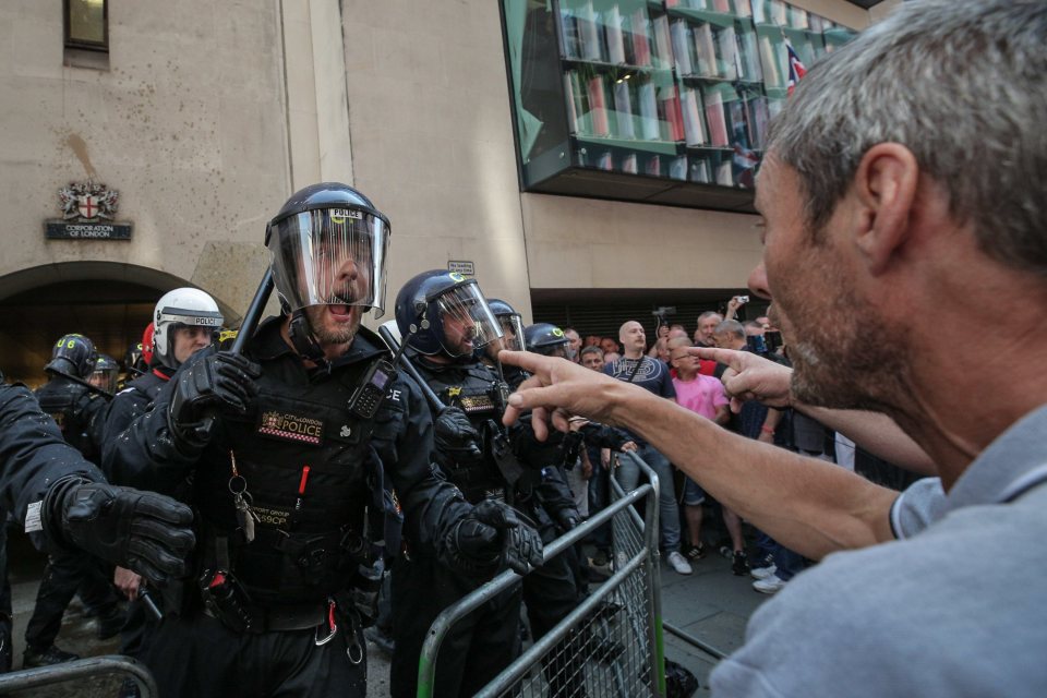  A protester and cop are locked in a stand off