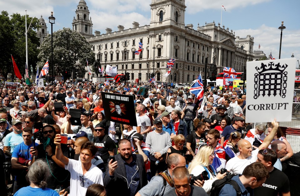  Protesters wave signs that read 'Corrupt' and calling for Robinson to be released