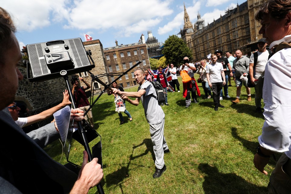  A man can be seen appearing to attack a BBC crew during the protests