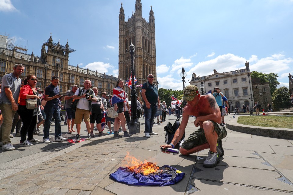  Tommy Robinson supporters set fire to an EU flag outside Parliament