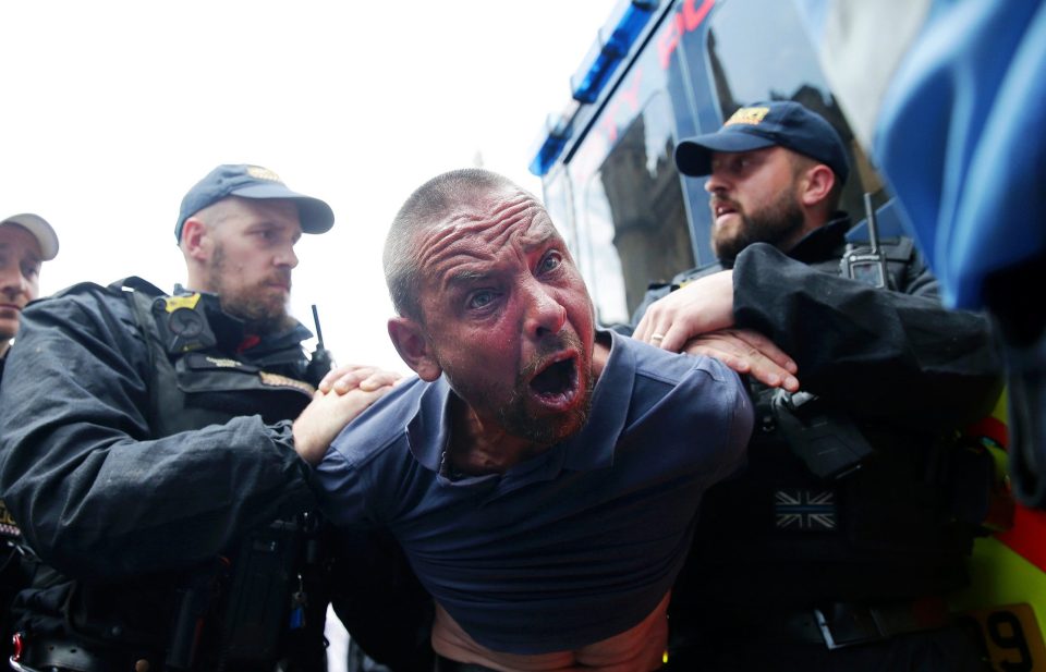  A protester is detained by police after scuffles broke out outside parliament