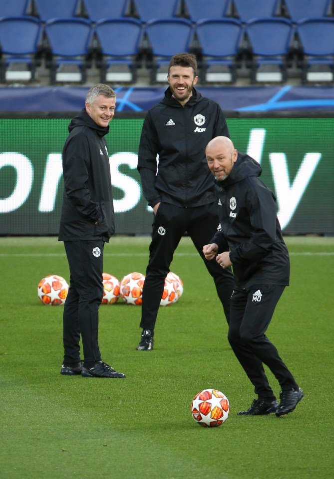  Ole Gunnar Solskjaer and coach Michael Carrick smile as Dempsey makes a pass