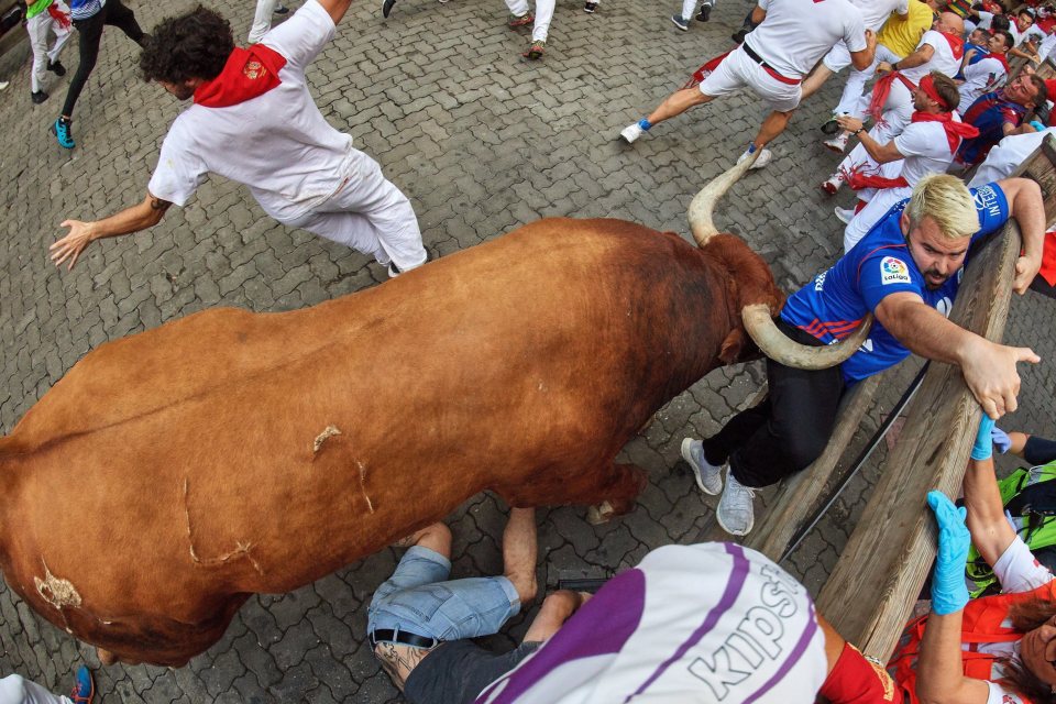  Two runners were nicked by the beast's horns after they were trapped against a wall during the festival's final run