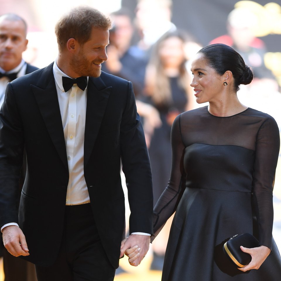  The Duke and Duchess of Sussex share a loving look while on the red carpet in London