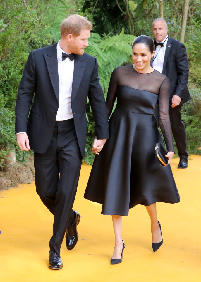  The couple beam as they walk down the red carpet