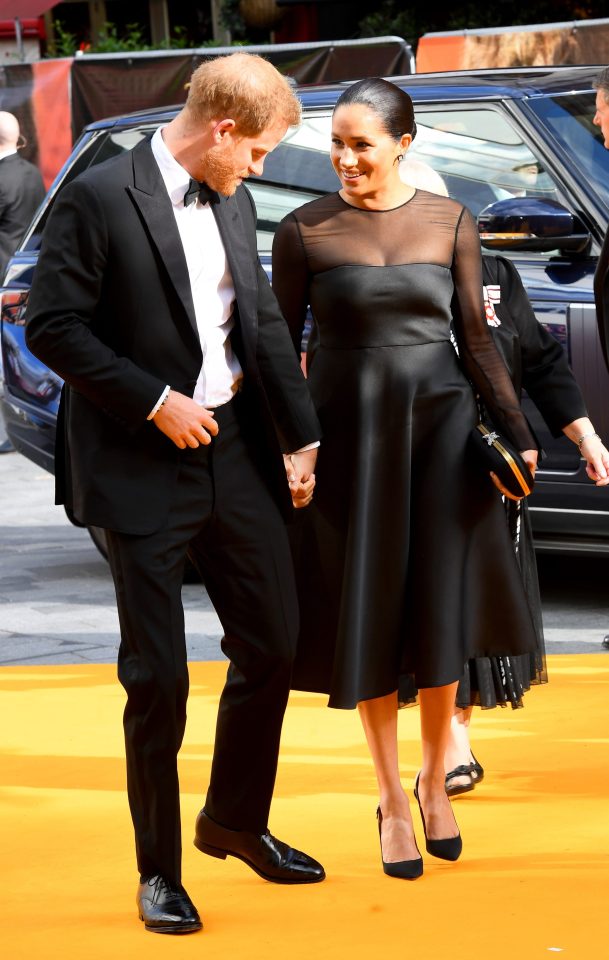  Prince Harry and Meghan chat as they arrive at Leicester Square