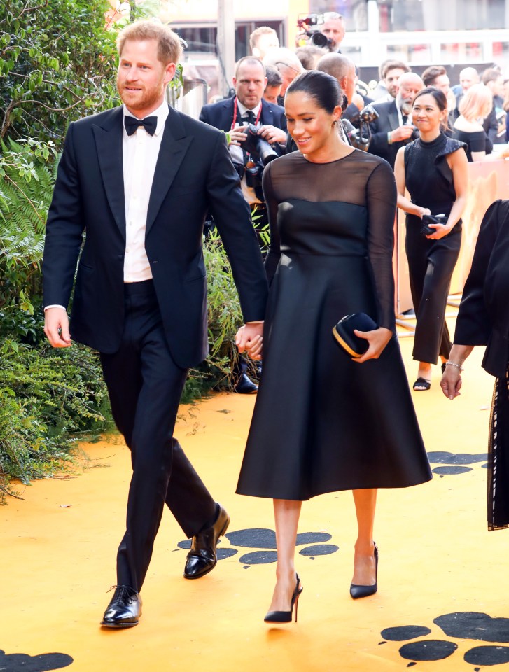  Meghan stunned in a £3,454 black A-line Jason Wu dress while holding a matching black clutch