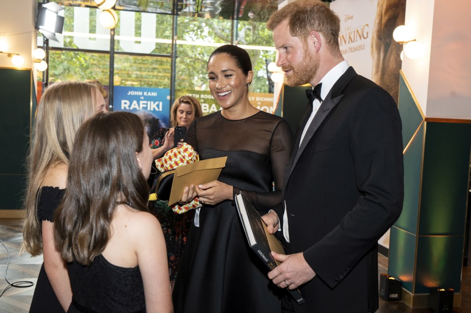  Evie Chambers, 12, and Valentina Walker, 12, whose parents are Disney executives, gave Meghan a bouquet, a book and a Simba toy for Archie