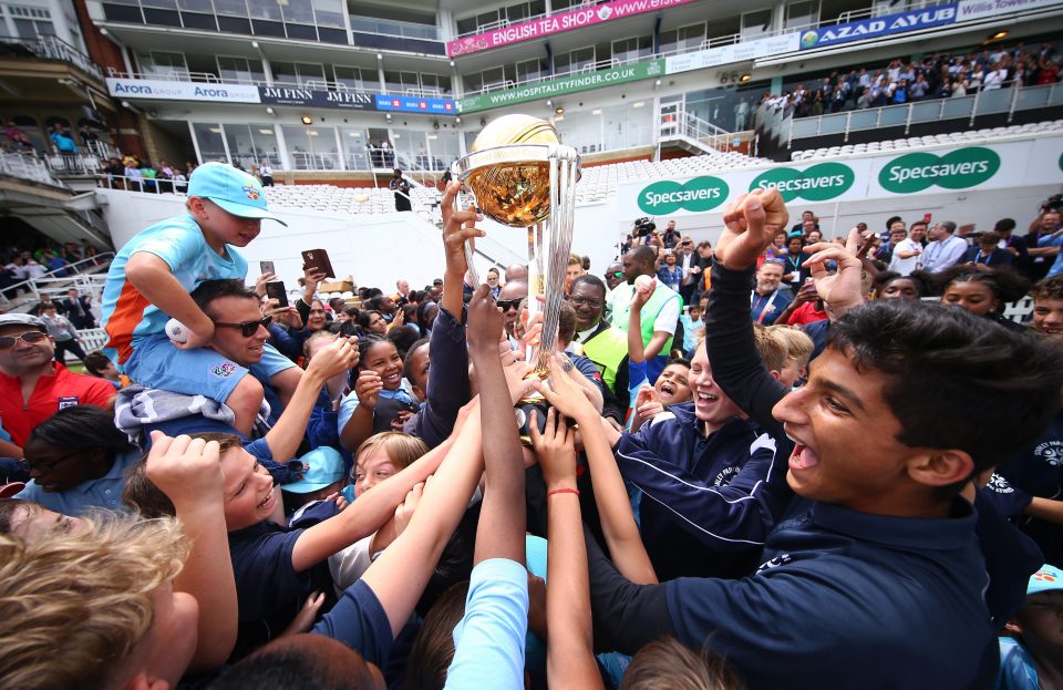  Children and cricket fans sprinted over to get their hands on the trophy at the Oval today