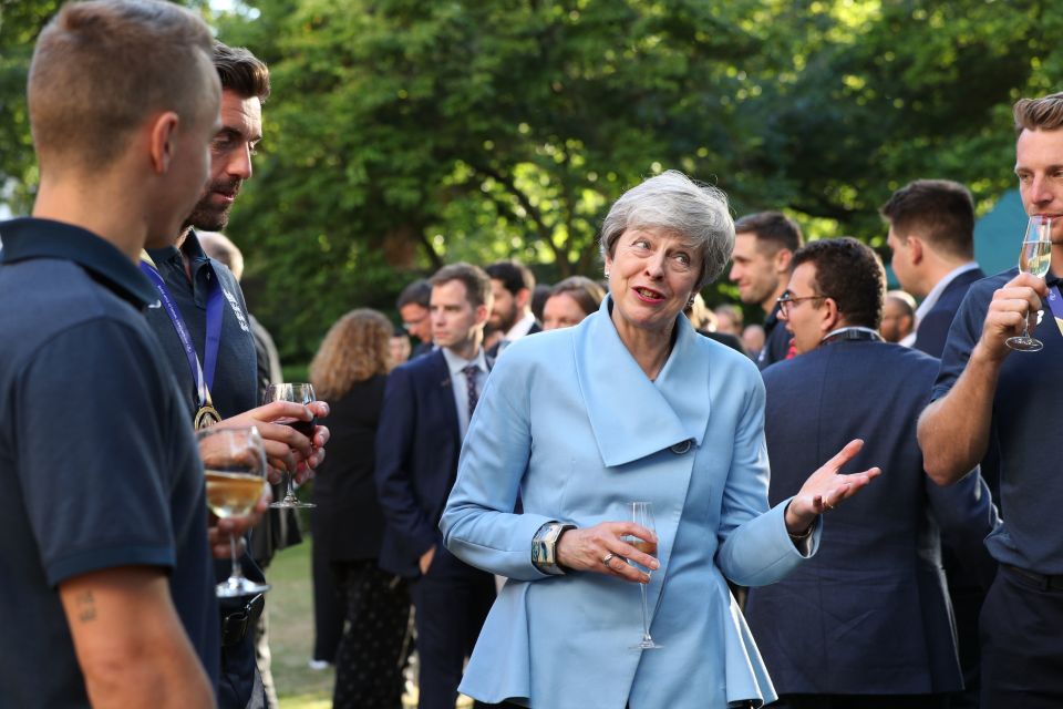  Mrs May chats with the players at the garden reception in Downing Street