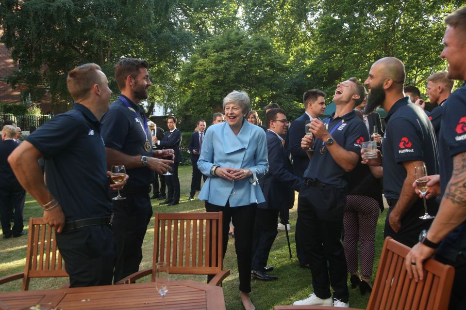  The PM shares a joke with a few of the England players as they sip champers