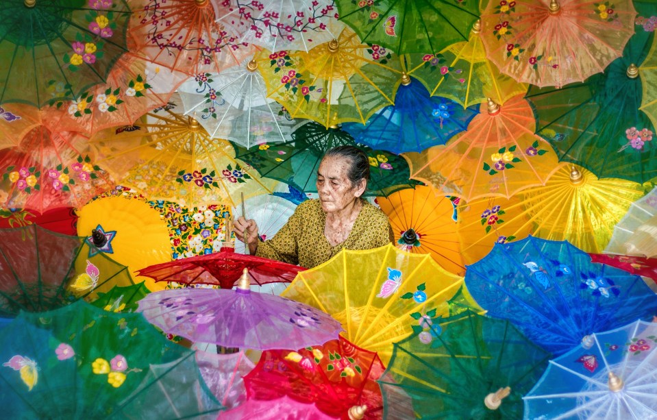  A craftswoman of colourful umbrellas in Indonesia