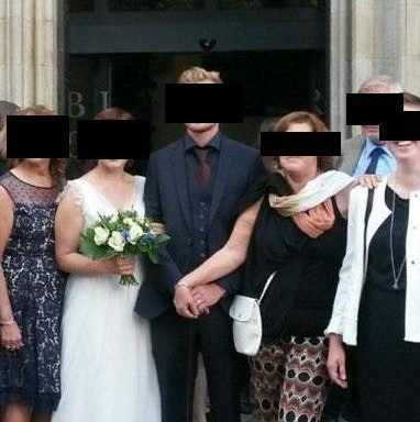 A mother-of-the-groom has come under fire for “clutching” her son and blocking out the bride in the wedding photographs