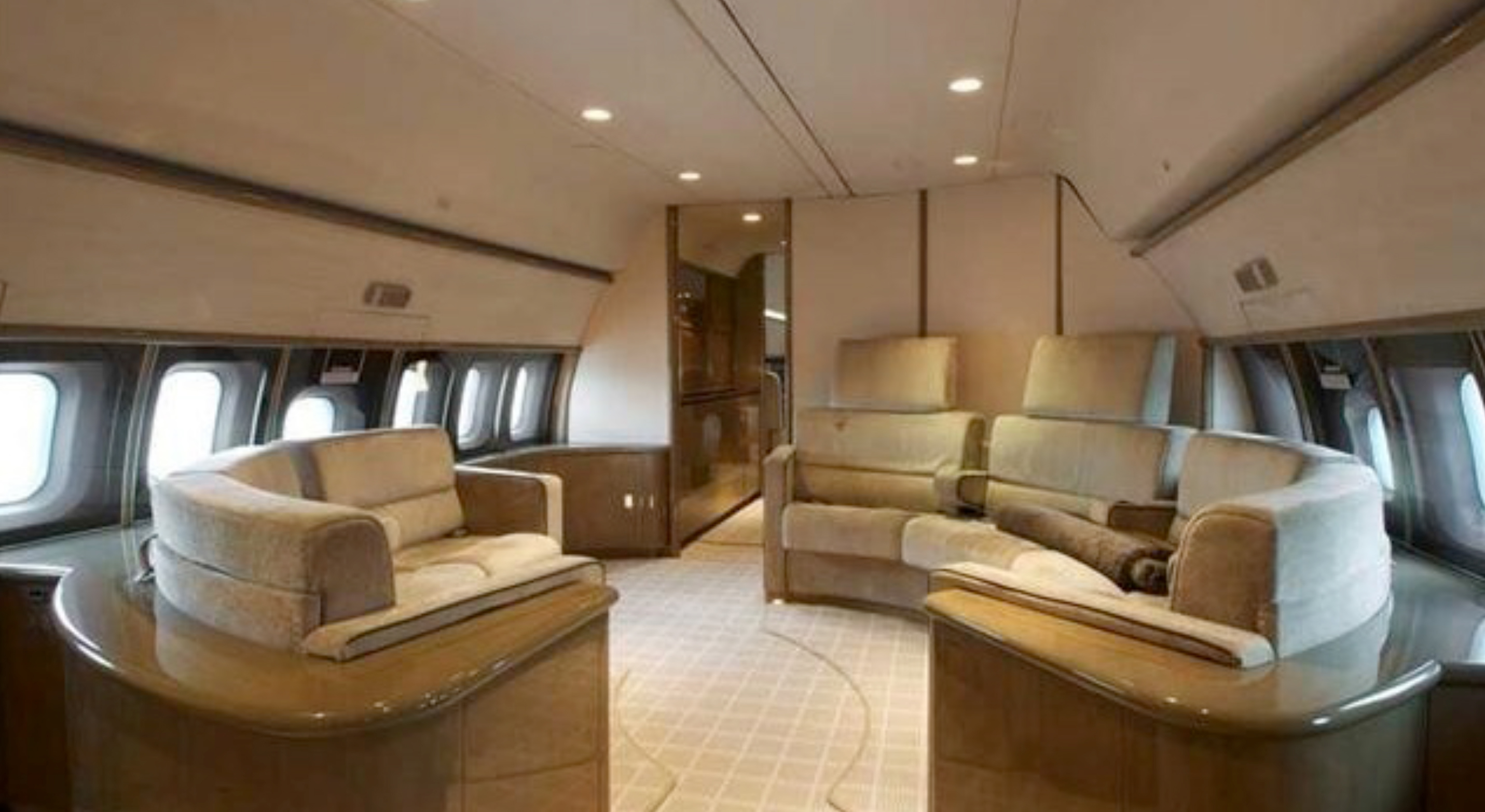 The luxury commercial jet features a circular shaped lounge filled with beige chairs