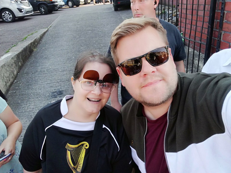  Fans pose with James Corden during filming