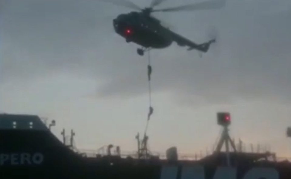  Soldiers abseil from a hovering helicopter while gunboats surrounding the Impero force it north towards Bandar Abbas