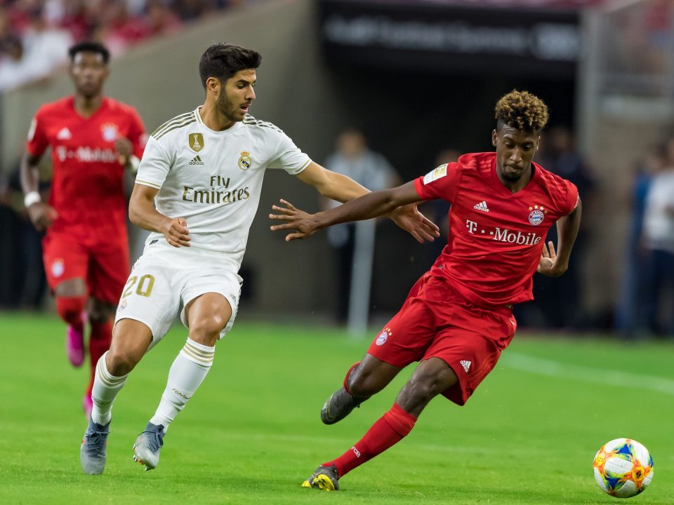  Marco Asensio chases down Bayern Munich's Kingsley Coman during Real Madrid's pre-season friendly with the Germans