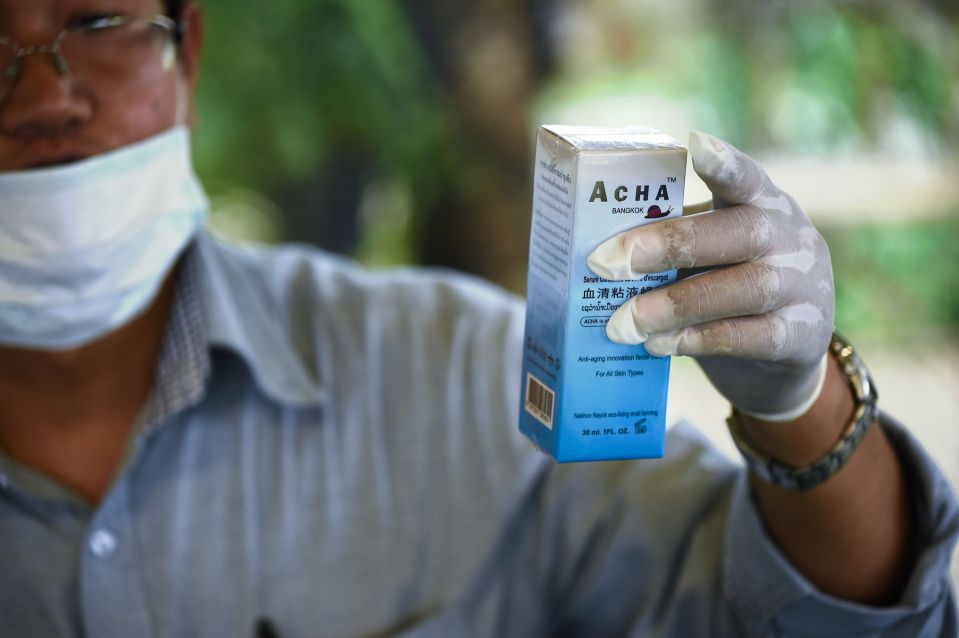  Kitpong Puttarathuvanun, founder and owner of the Acha Snail Serum brand, holding a box of his company's serum