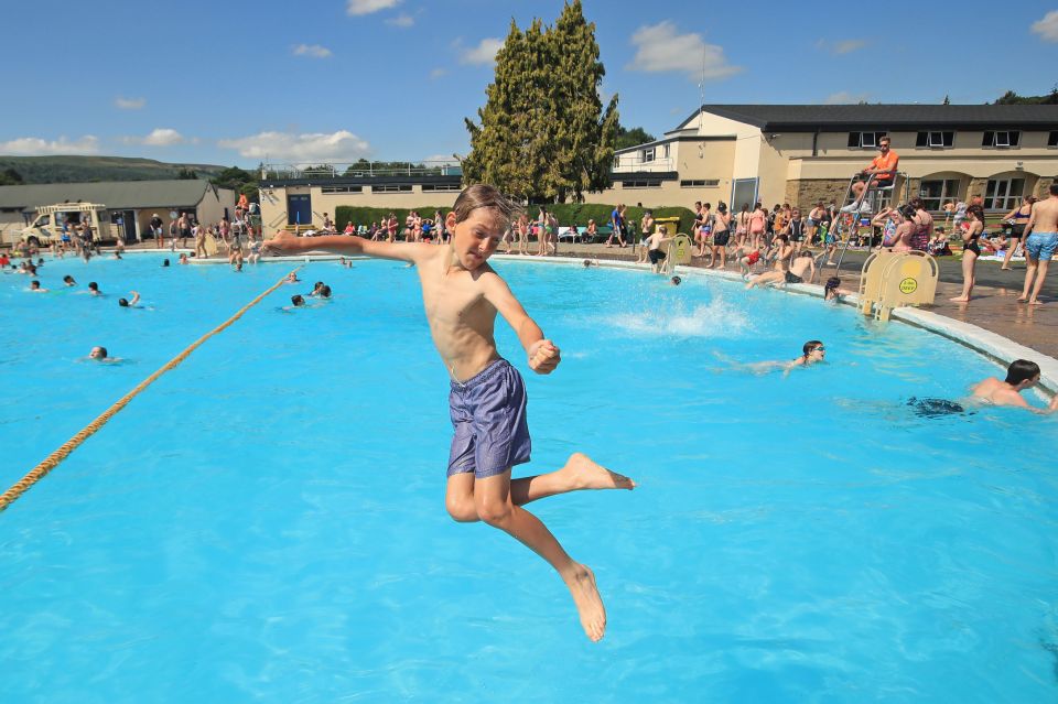  A boy plunges into a pool in Ilkley on the first day of the summer holidays