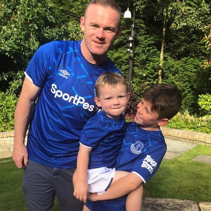  Wayne Rooney posed with two of his sons in Everton shirts given to him by the club